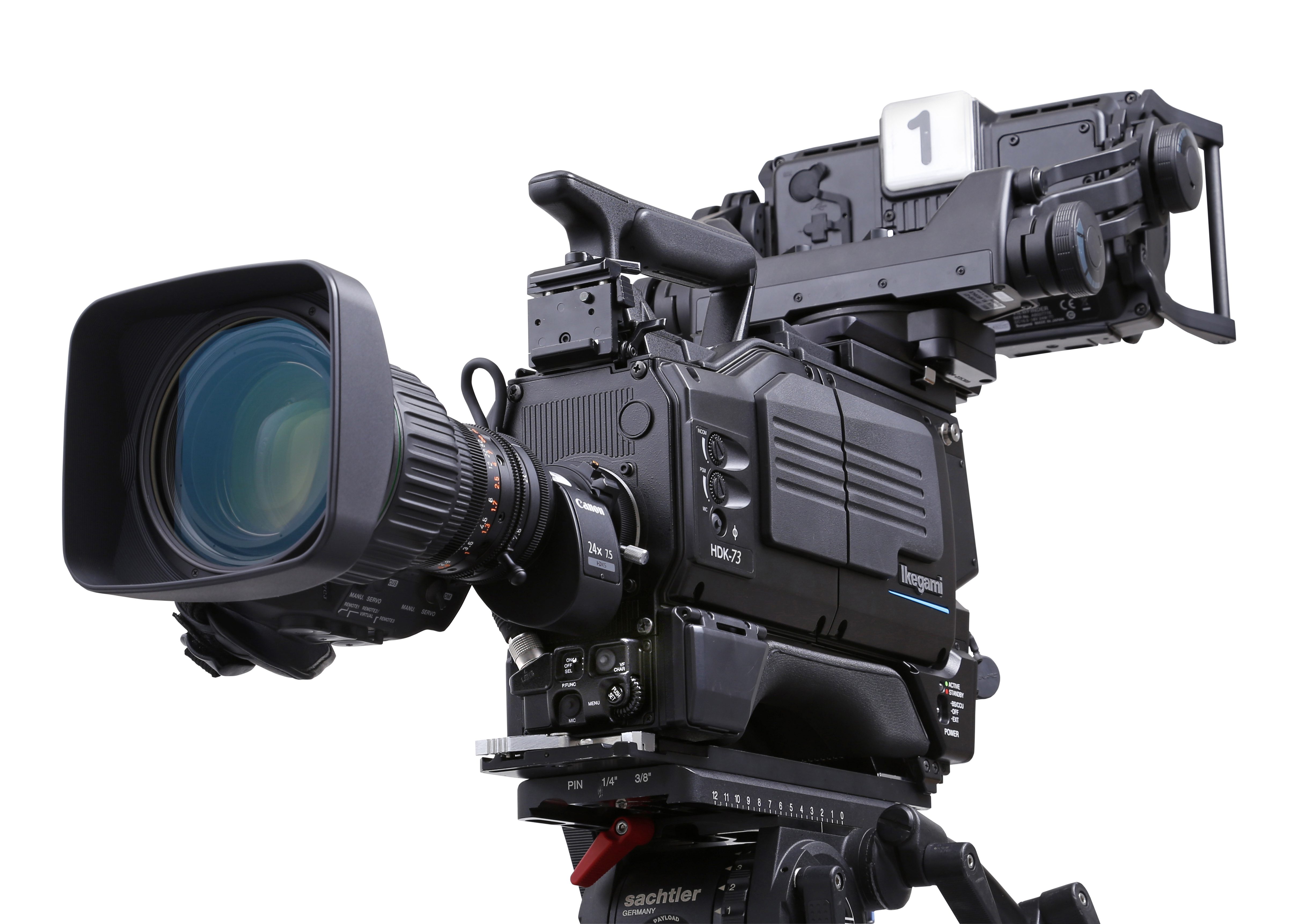 Professional broadcast camera with a large lens and studio setup.
